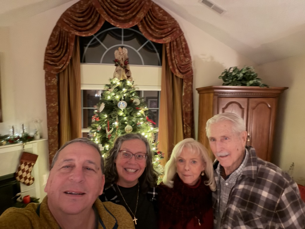 Steve and Colleen with family in front of a Christmas tree in Virginia
